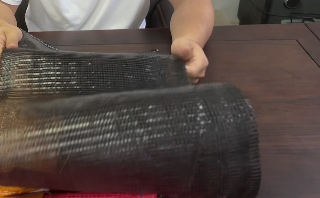 Inspecting a black mesh bag